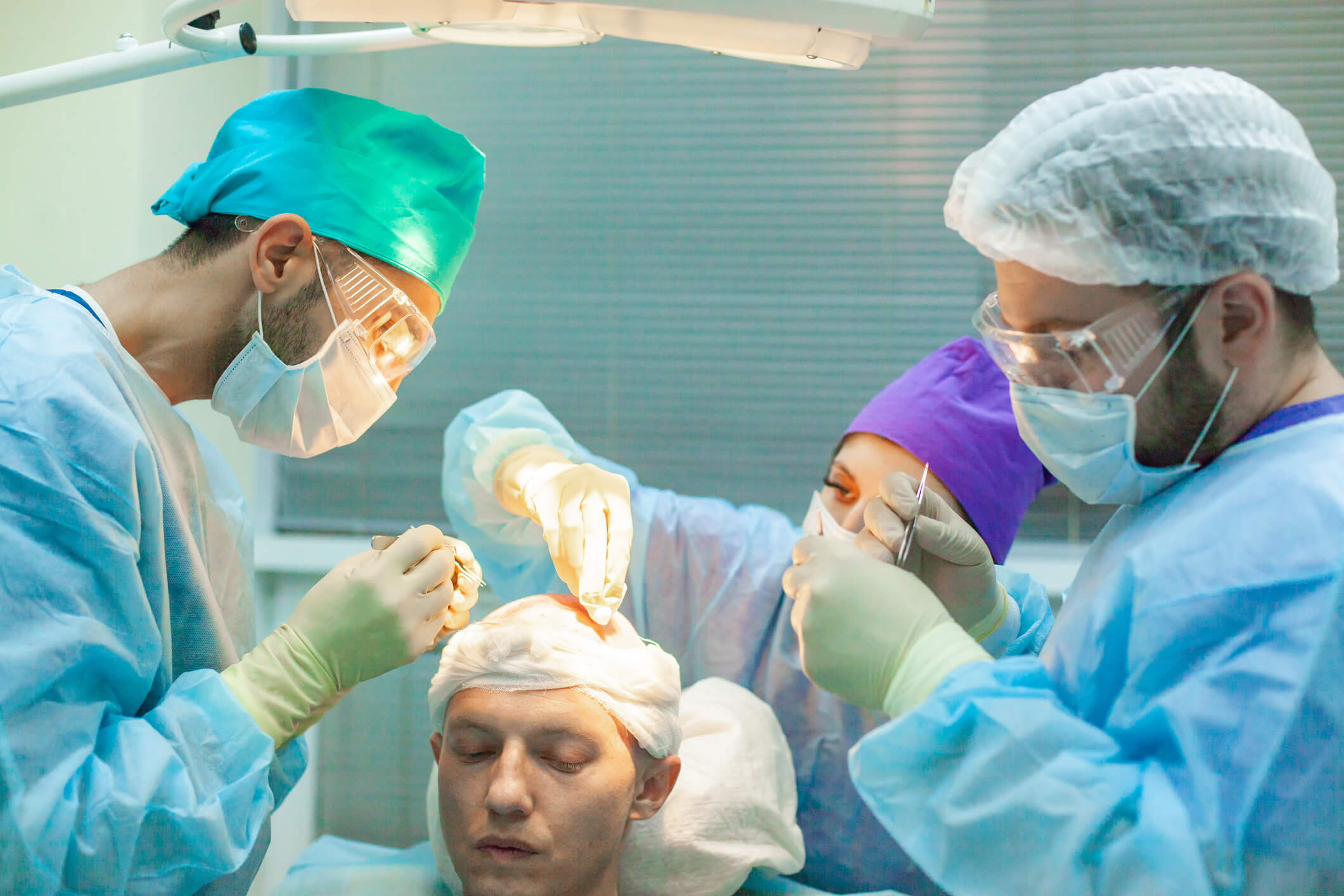 How Does Hair Transplant Works Three licensed surgeons doing hair transplants to a customer in Newport Beach, California at Neograft Hair Restoration Orange County